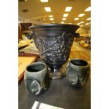 Holkham pottery, large classical black urn style vase and two owl eye mugs