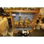 Model ship in oak cabinet
