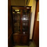 Narrow mahogany bookcase on cupboard