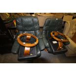 Pair of "Stressless" green leather recliners and foot stools