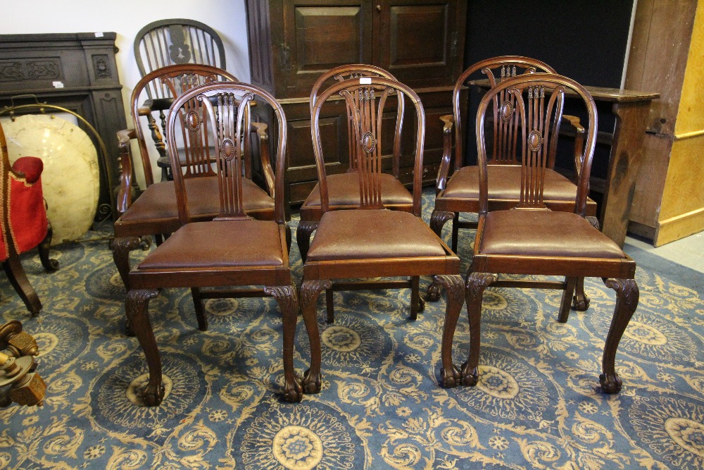 Set of six 1920's mahogany dining chairs of Sheraton design, including two armchairs, vinyl drop