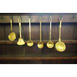 Early 19th Century brass circular chestnut roaster, cream skimmer, three ladles and a shallow pan