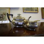 George V silver two piece tea service, with plain squat bodies - teapot and cream jug, by Walker and