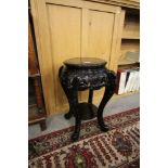 Late 19th Century ebonised two tier jardiniere stand of Oriental design, 60cm high (old repairs)