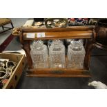 Oak Betjemann's patent tantalus with 3 bottles