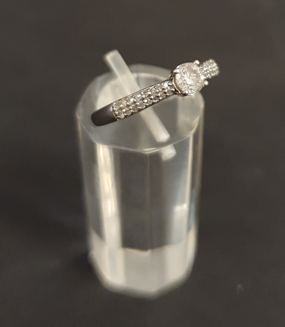 White Metal and Diamond Solitaire Ring and Diamond Chip Shoulders