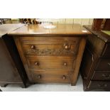 Oak chest of drawers with carved top drawer