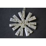Modernist silver pendant of Starburst design, with silver chain