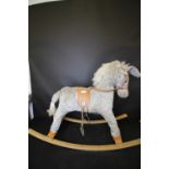 Childs rocking horse and box of toys
