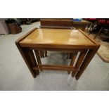 Nest of three glass topped teak tables