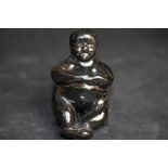 Black glazed stoneware figure - seated nude man