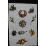 Two white metal filigree design brooches and eight other costume jewellery brooches