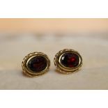 A pair of yellow metal and red stone earrings - the clasps marked .375