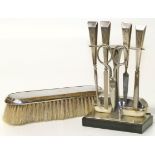 A 1930's manicure set and silver backed brush Condition reports are not availabe for our Interiors