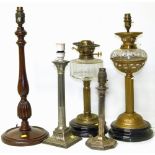 A collection of five column lamps, one silver, on silver plate, two brass and one turned wood
