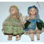 Pair plaster dolls, 14cm long with original clothing and moveable limbs. Condition reports are not