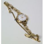 9ct gold ladies vintage wristwatch in rolled gold bracelet, white enamel dial with Roman numerals,