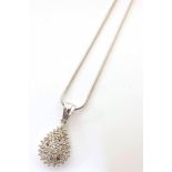 9ct white gold diamond set pear-shaped cluster pendant on a 9ct chain. Condition reports are not