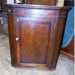 George III oak and cross-banded corner cupboard with shaped interior shelves. Condition reports