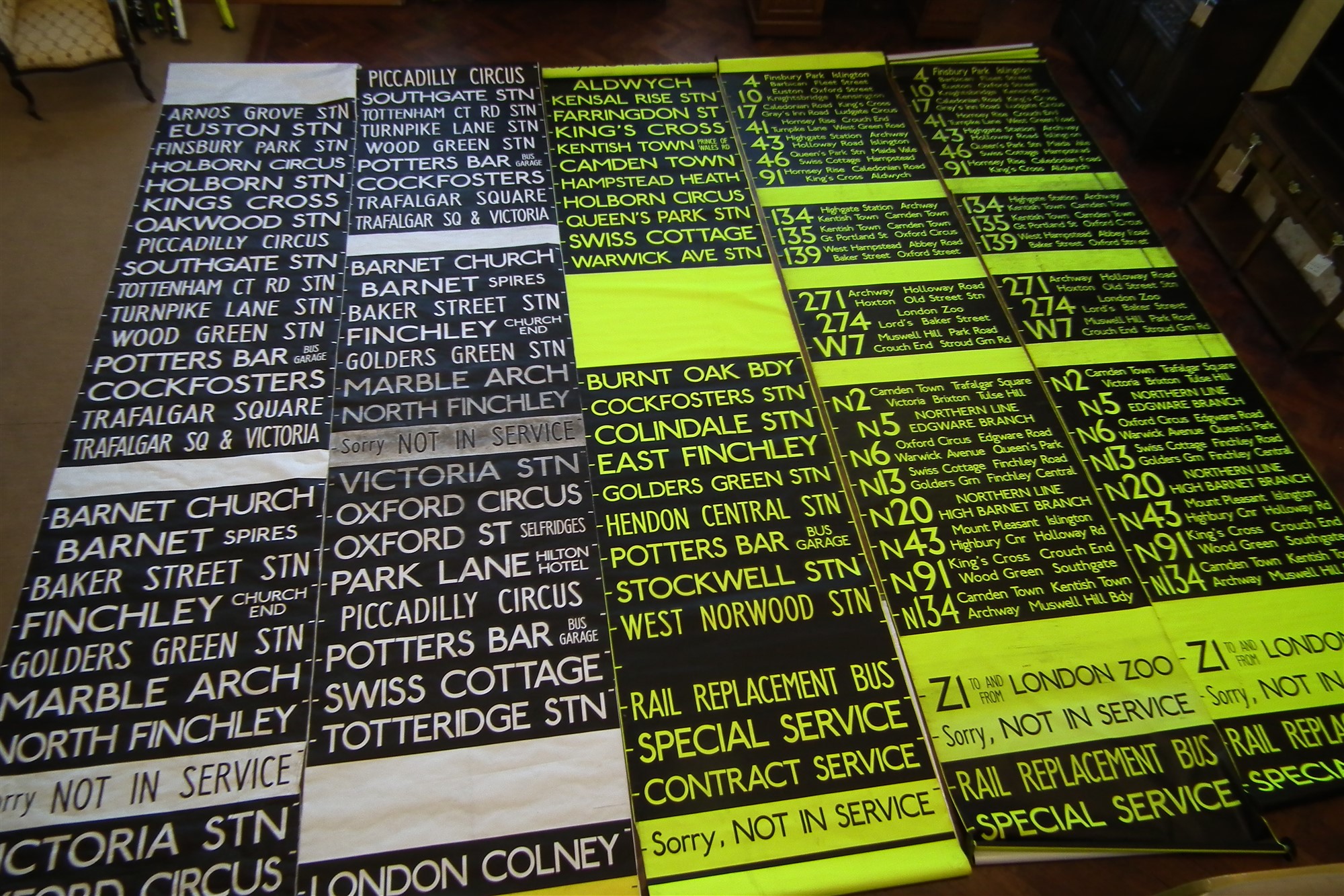 Five London Transport Bus destination blinds in yellow and black and white.