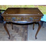 Victorian oak fold-over card table enclosing two draers. Condition reports are not available for our