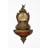 A 19th century Louis XIV style bracket clock and bracket. The red tortoiseshell boulle veneered case