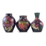 Three small Moorcroft vases, decorated with Leaf and Berry pattern, Hibiscus and Clematis