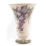 Moorcroft wisteria pattern vase , decorated on a cream coloured back ground with green borders, 22cm