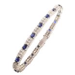 Sapphire and diamond two-row 18ct white gold line bracelet , comprising 15 oval mixed cut blue