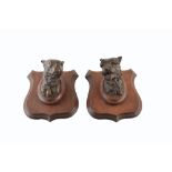 Two bronze dogs heads of a mastiff and a terrier mounted on oak shields, after Prosper LeCourtier (