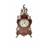 A 19th century Louis XIV style mantel clock. Veneered in tortoishell with brass mounts, feet and
