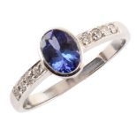 Tanzanite solitaire 18ct white gold ring with diamond set shoulders, mixed cut oval tanzanite