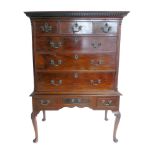 George III mahogany chest on stand, top with key pattern fretwork cornice, three short drawers above