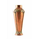 An Art Nouveau copper and brass vase by the WMF Group, Berlin. The hammered copper vase middle is