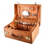 Crocodile skin leather cased silver travelling set , 15 pieces of silver and glass dressing table