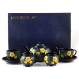 Moorcroft boxed tea for two set, decorated with buttercup pattern after Sally Tuffin, to include