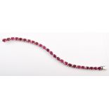18ct white gold ruby set line bracelet, 25 oval mixed cut rubies each measuring approx. 6mm x 4mm,