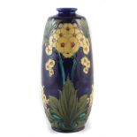 Minton Secessionist vase , tube lined with flowers on a blue ground, incised 3707 to base, 32cm