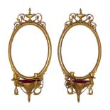 A pair of Regency Gesso framed oval Girandole wall mirrors, each with classical urn and swag