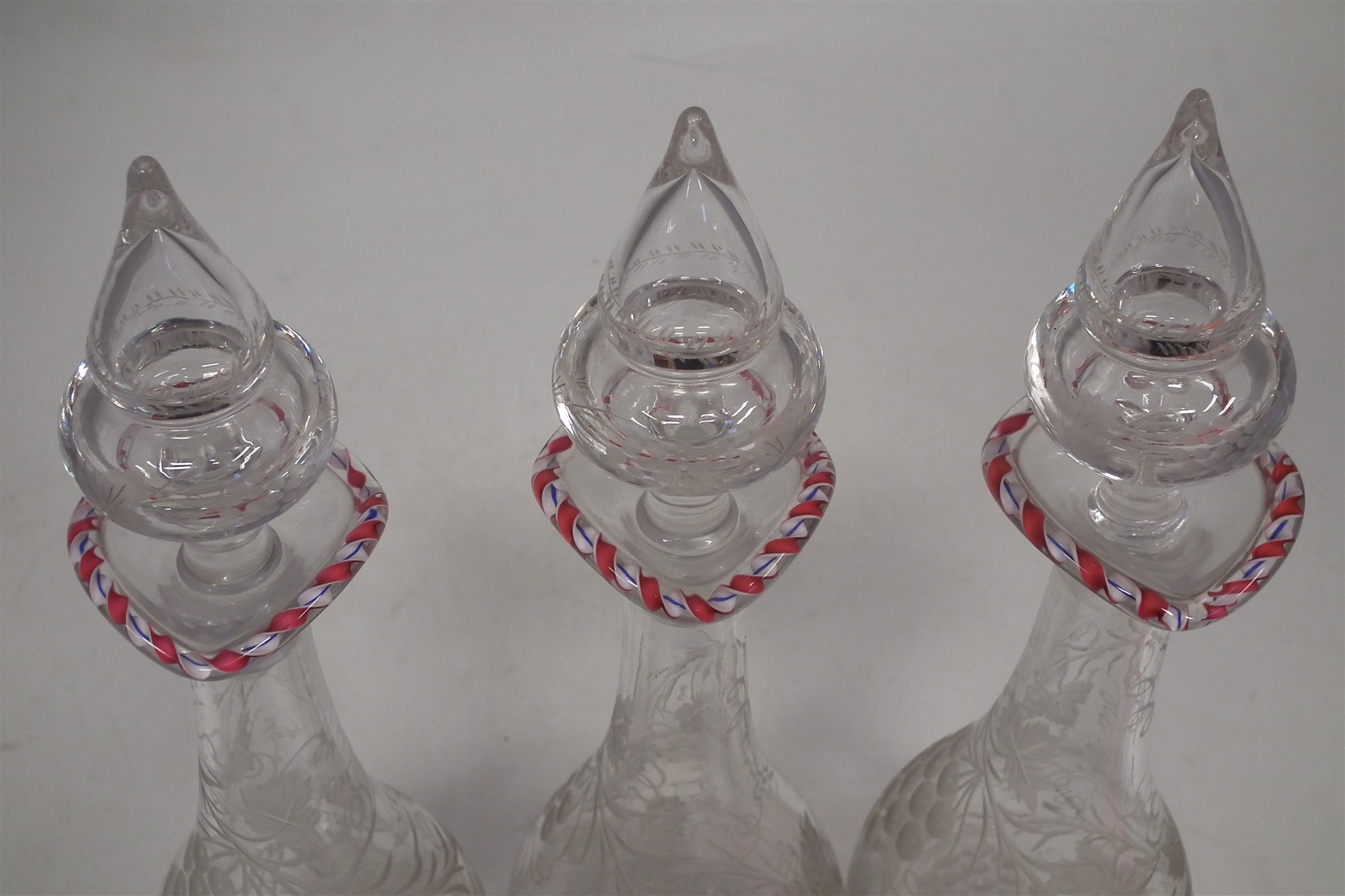 Set of three Victorian decanters, engraved with leaves and berries below coloured twisted cane rims, - Image 3 of 8