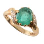 Emerald and diamond 18ct yellow gold ring , the central mixed cut oval emerald measuring approx. 9mm