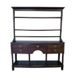 George III oak North Wales dresser, three shelf rack with moulded cornice above base with five