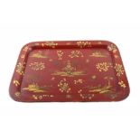 A Victorian papier-mâché chinoiserie tray. A gilt pagoda with floral motifs on scarlet background.