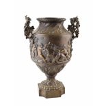 A mid-19th century French bronze urn. With twin-handles taking the form of grape vines held aloft by