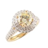 Yellow and white diamond 2-tier cluster ring with diamond set shoulders , the central light yellow