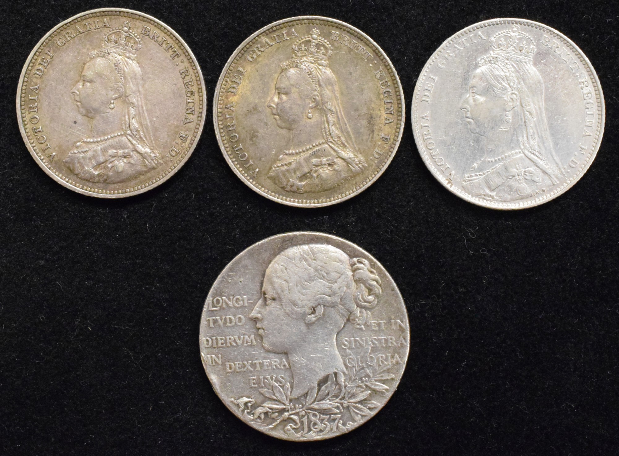 Three Queen Victoria Shillings and a Victoria Diamond Jubilee silver medal (4).