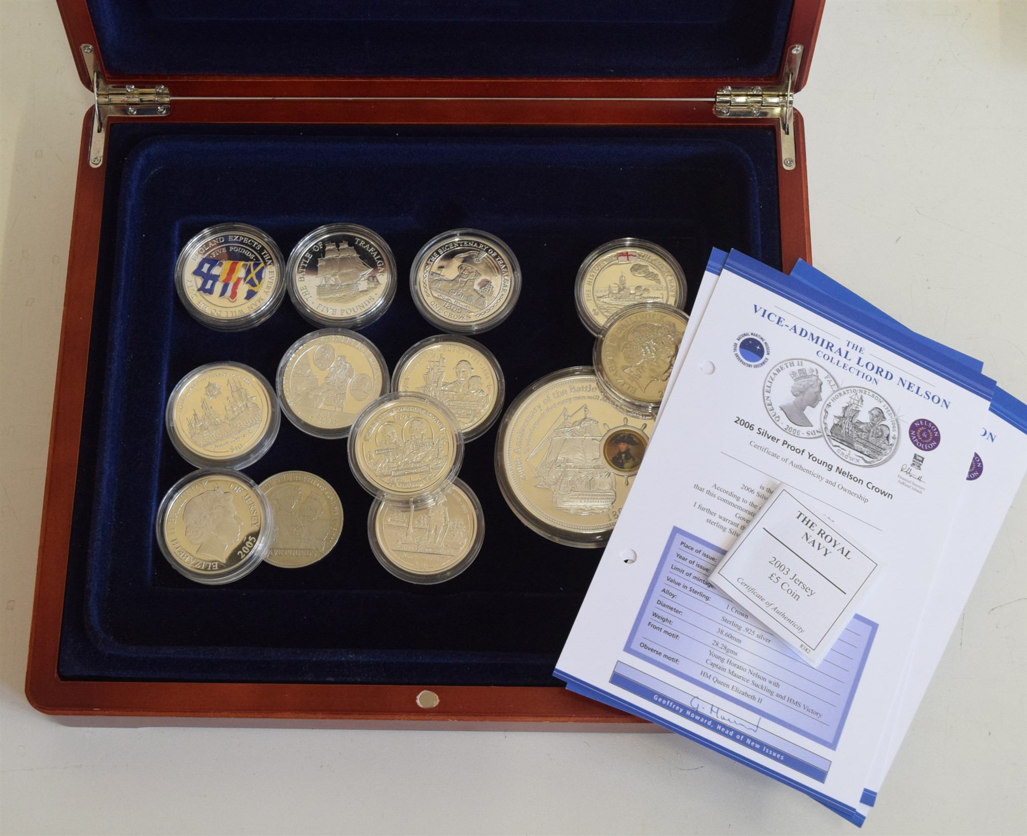 Assortment of various maritime themed modern commemorative coins and three coin covers.