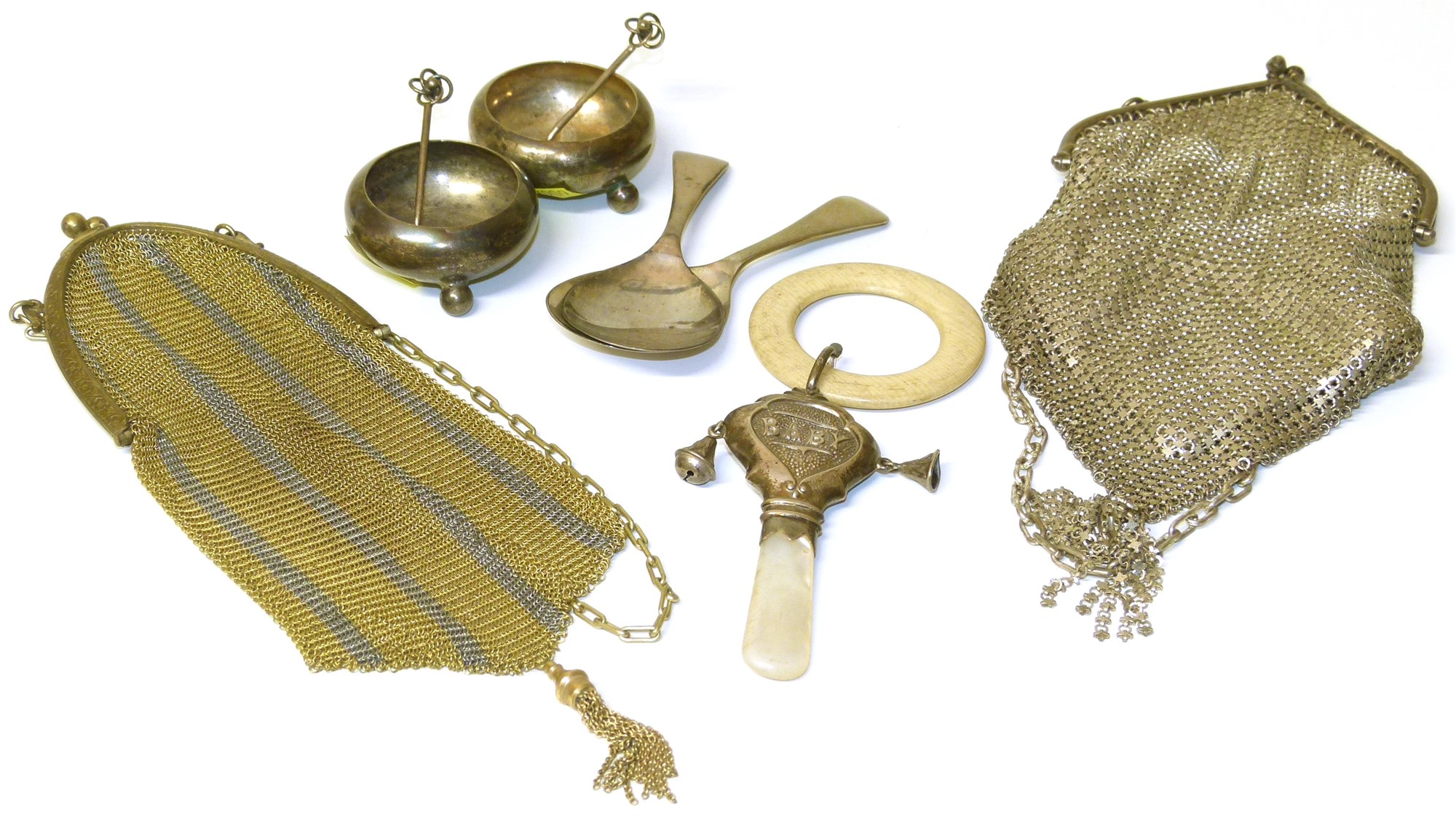 Two evening bags, two open silver salts, two silver caddy spoons and a baby rattle. Condition