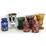 Seven Victorian coloured glass vases (amber, green and blue undamaged, the rest chipped).Condition