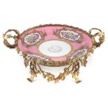 Sevres Chateau De Bizy ormolu mounted charger, painted with flowers within raised gilt cartouches on